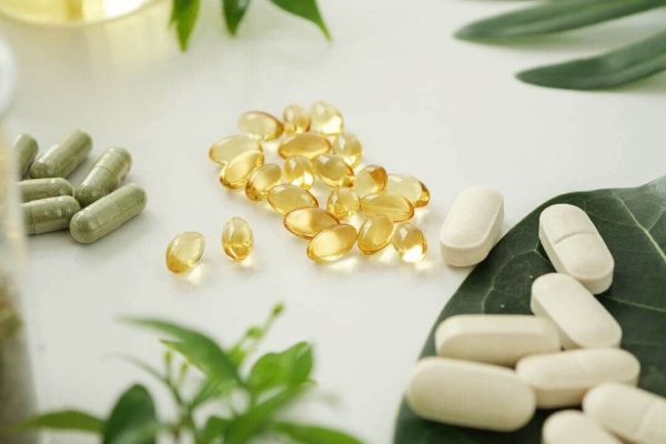 vitamins-and-supplements-among-greenery